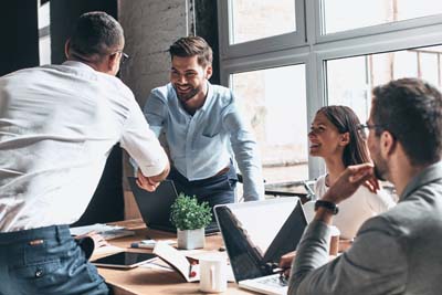 Hommes se serant la main autour d'une table